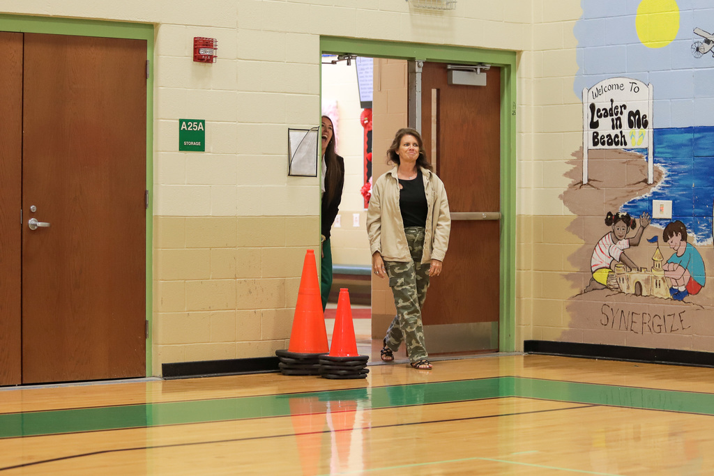 Surprised with cheers- Ann Bolin walks into student assembly 