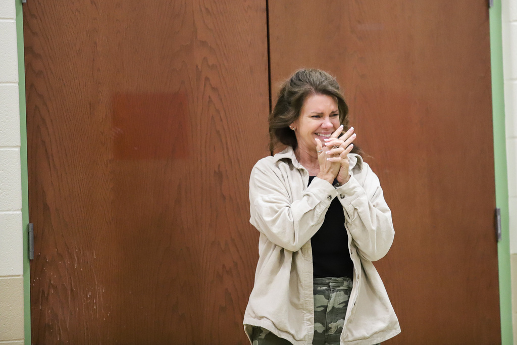 Surprised with cheers- Ann Bolin walks into student assembly 