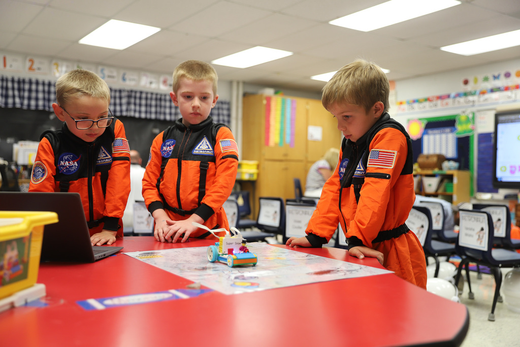 Kindergarten astronauts coding LEGO robot