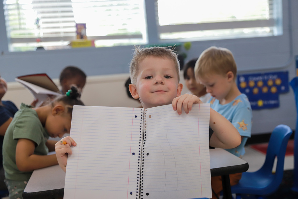 Preschool student shows his artwork