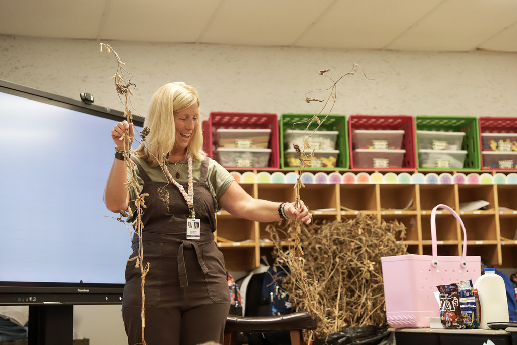 Mrs. Dotson shows first graders soybean plants