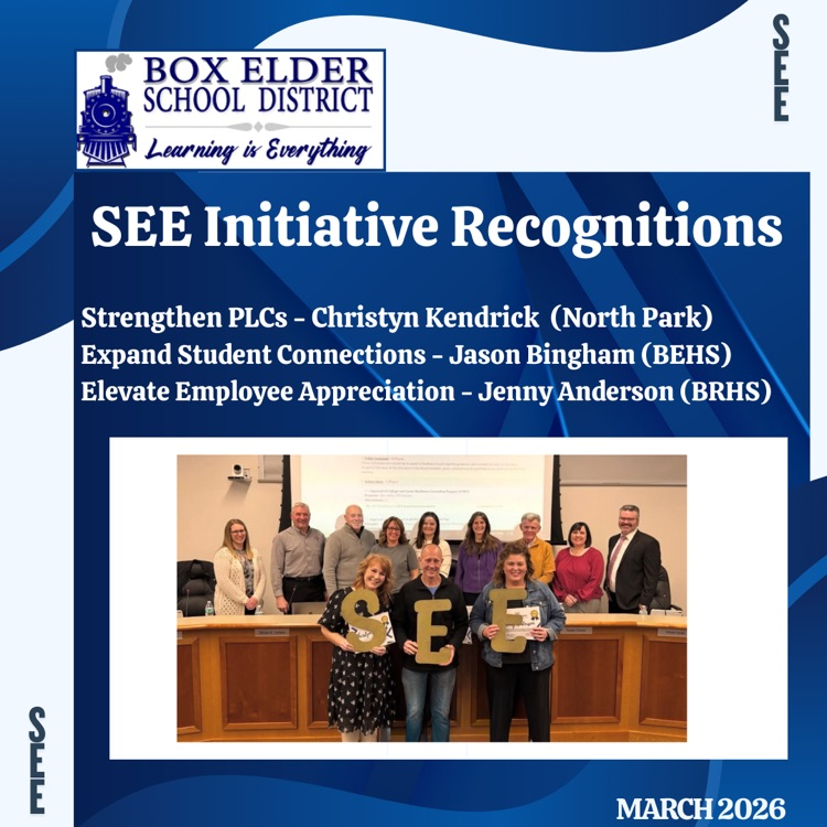 SEE Award recipients holding the letters SEE at board meeting