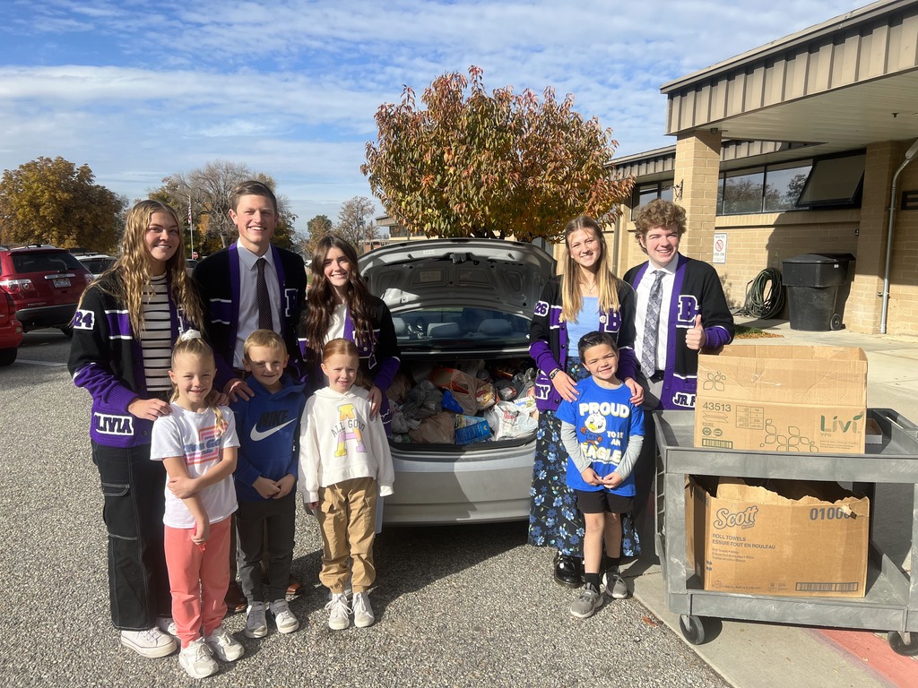 BEHS Student Government student with Willard Students and the food they collected for the food drive.