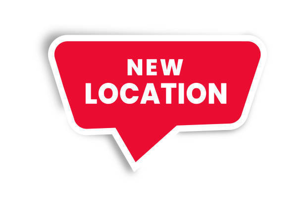 "New location" sign (red background with white letters)