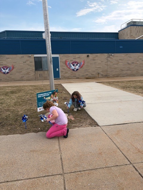 Students put up pinwheel garden for child abuse prevention month