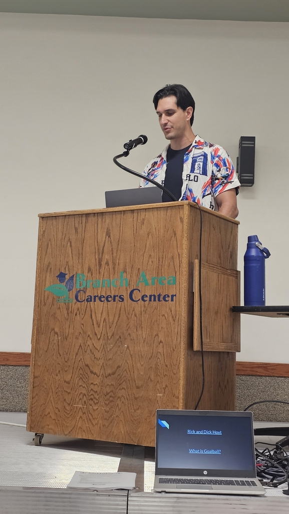 Tyler Merren speaking at podium