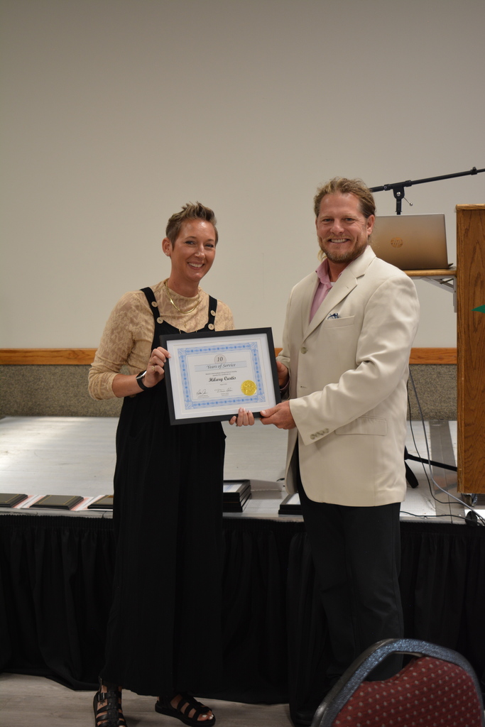 Staff Member and Director holding certificate