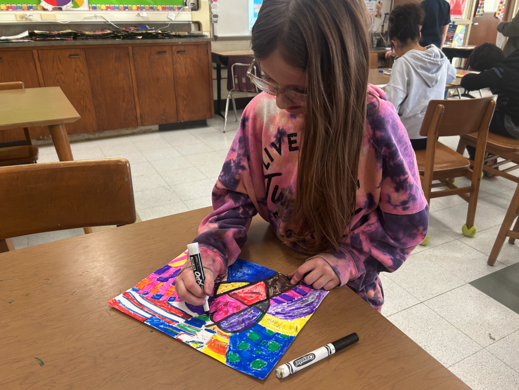 a young coloring with a marker