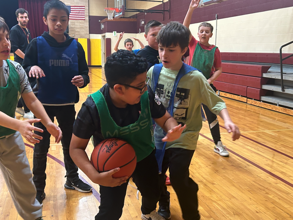 young boys in elementary playing basketball