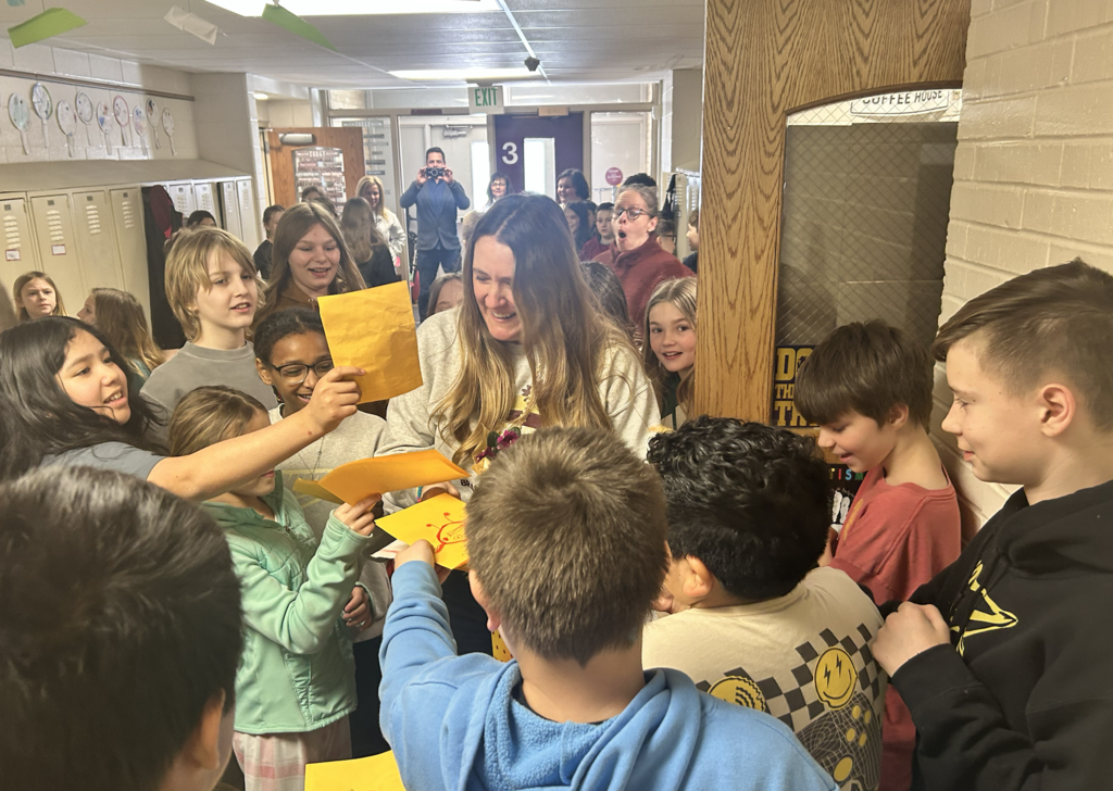 group of kids surrounding counselor