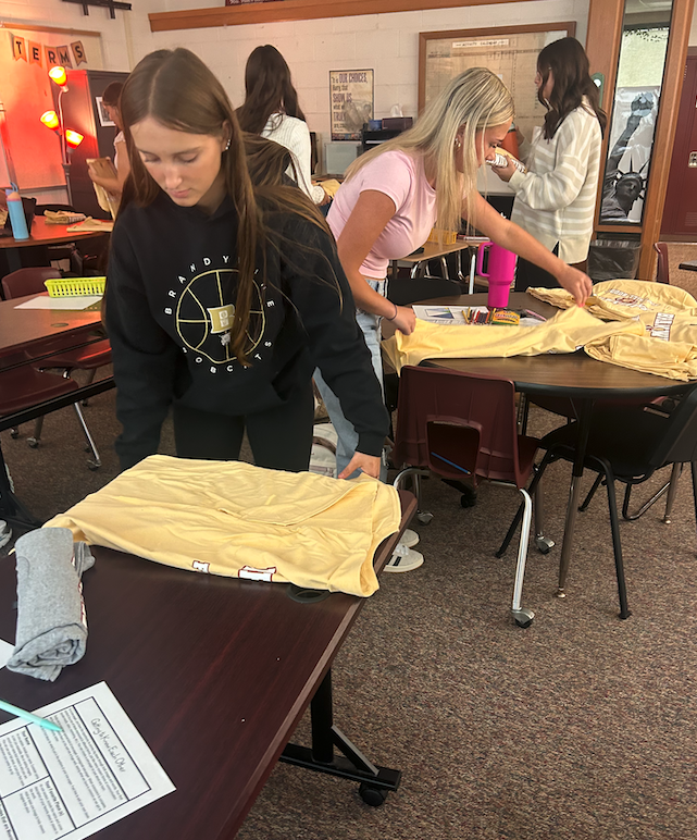 students organizing shirts