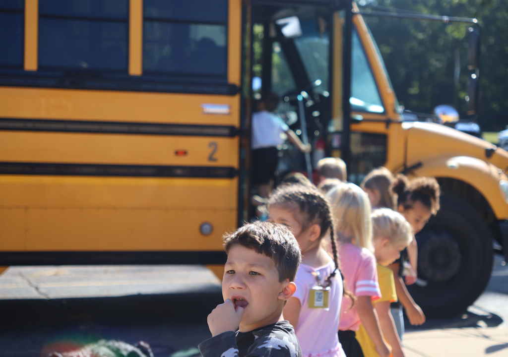 group of kids going onto a bus