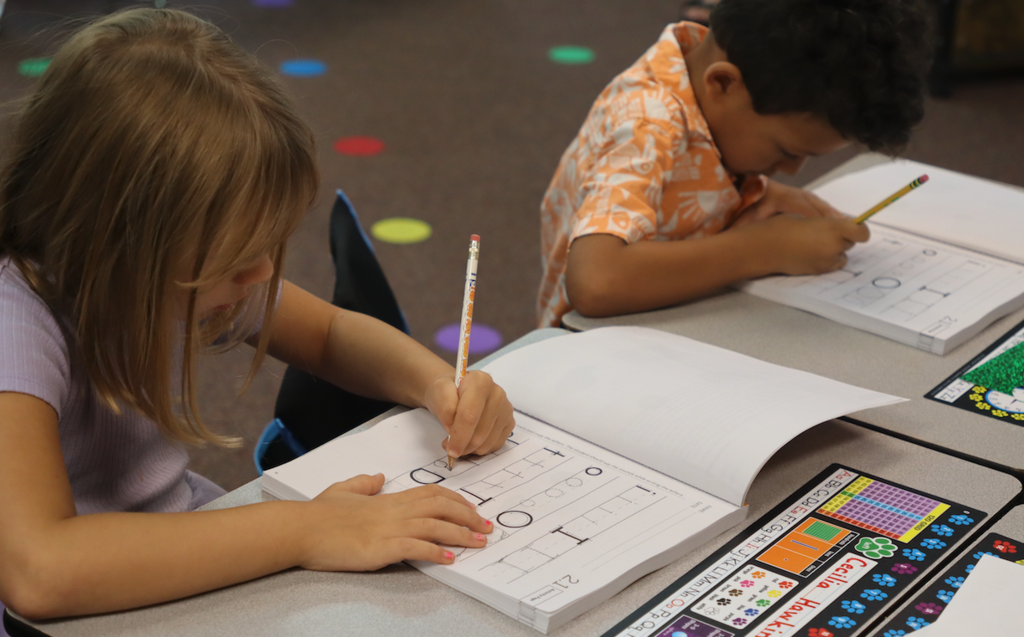 little girl and boy practicing handwriting