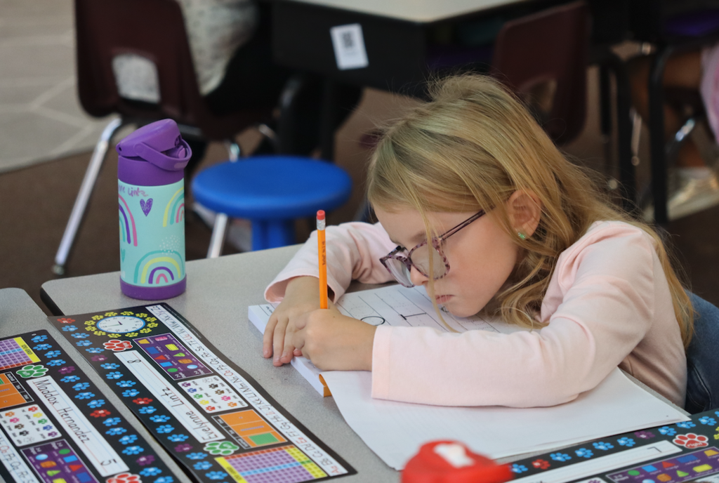 little girl practicing her handwriting