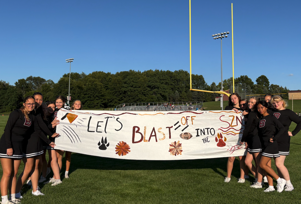 cheerleaders holding sign
