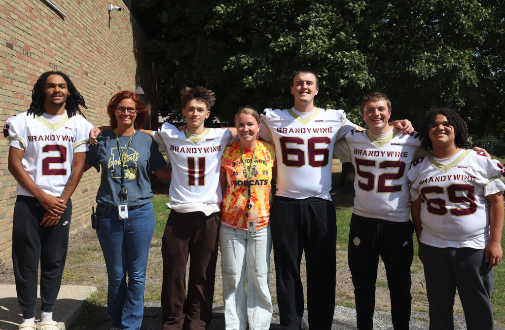 group of football players with teachers