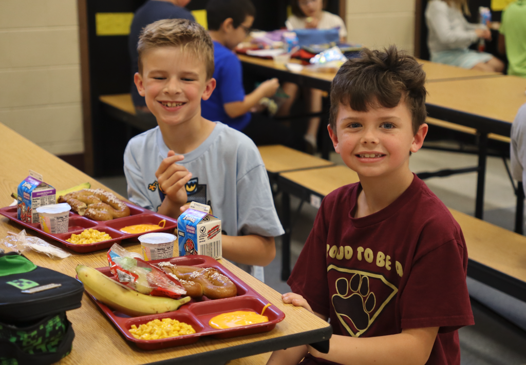 two boys eating lunch
