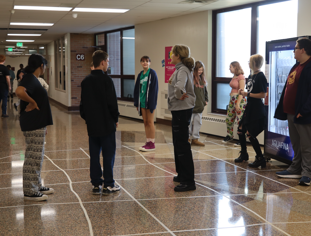 group of students standing int he hallway