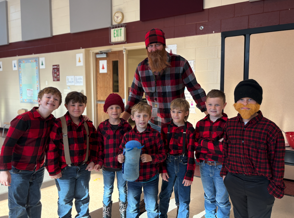 a bunch of little Paul Bunyans with a large Paul Bunyan
