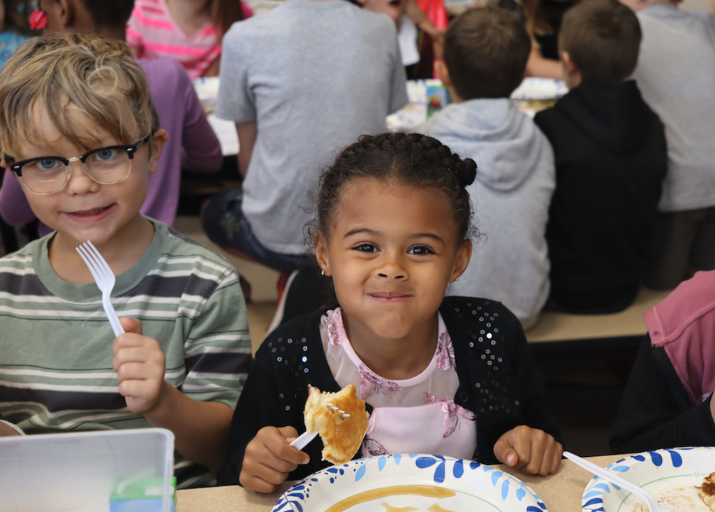 little girl eating pancakes