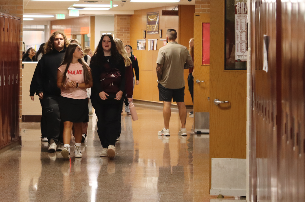 two girls walking down the hallway