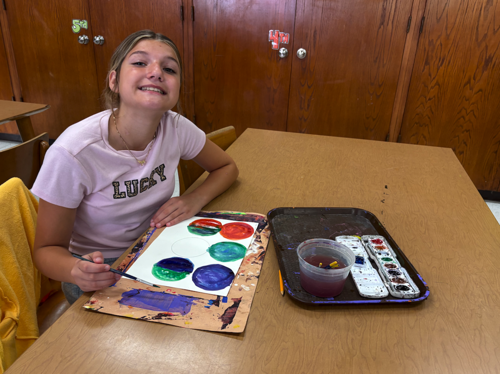 student making dots in art class