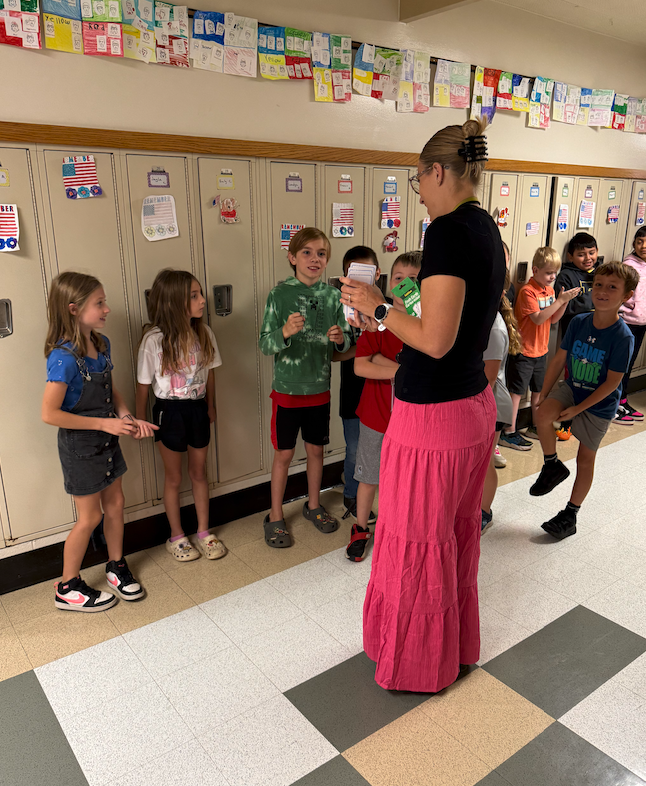 students standing in the hallway with teacher