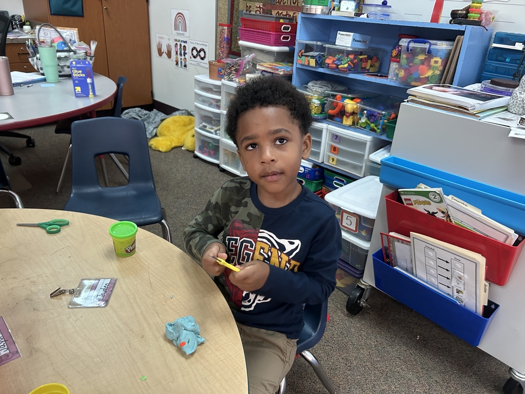 little boy practicing with scissors