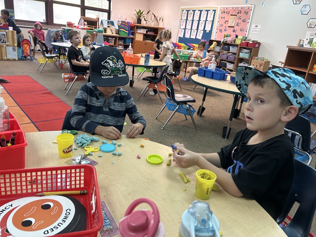 two little boys practicing with scissors