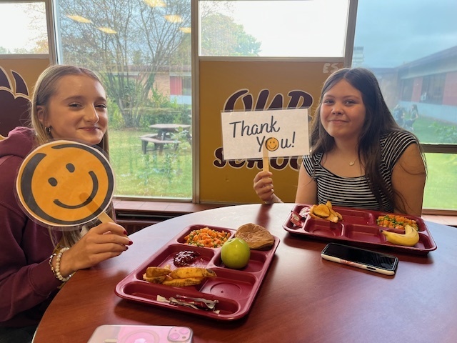 student with thank you sign