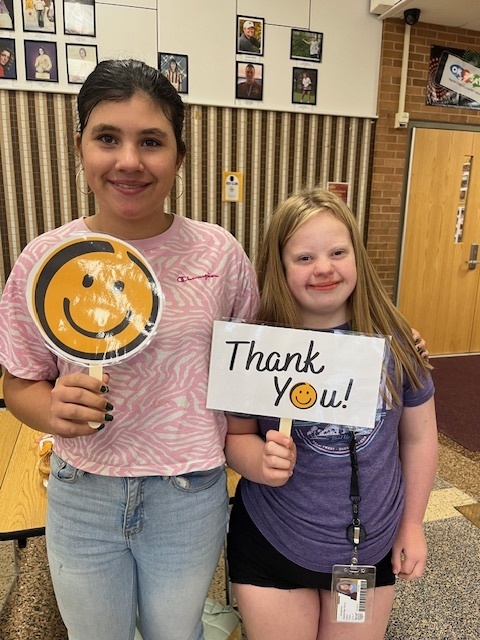 two students with thank you sign