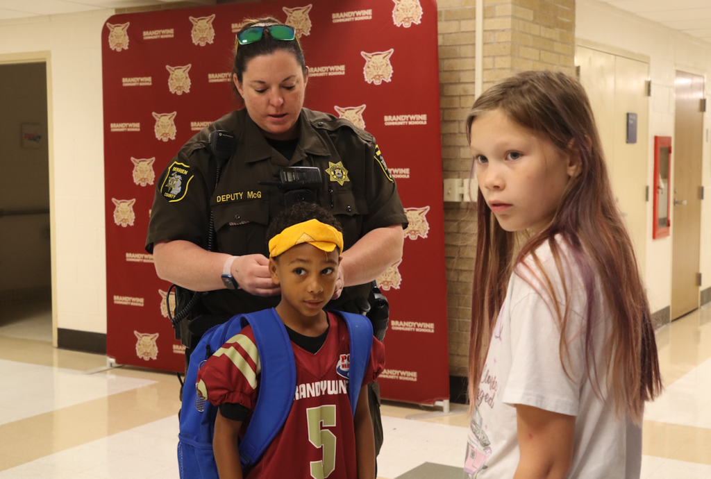 SRO putting bandana on kid