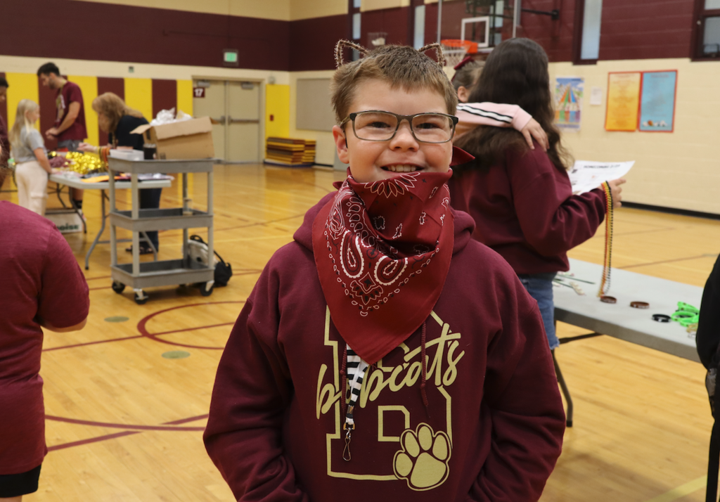 young boy in maroon and gold