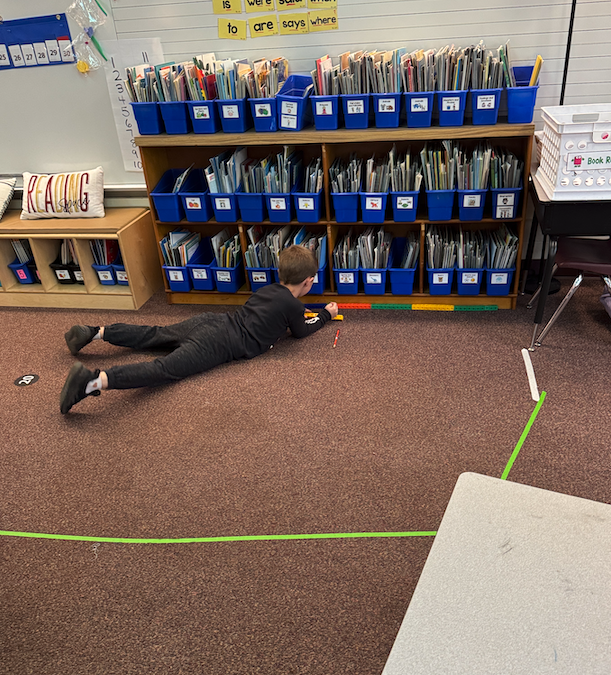 student measuring on the ground