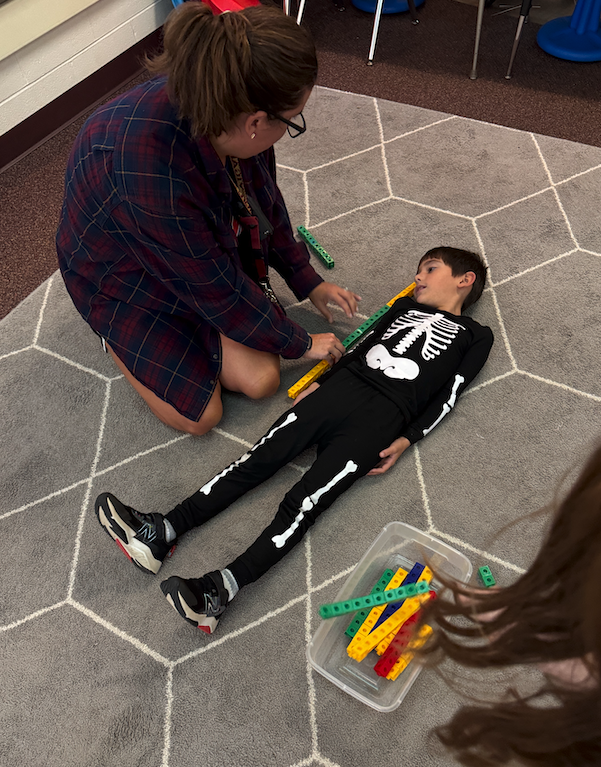 student laying on the ground