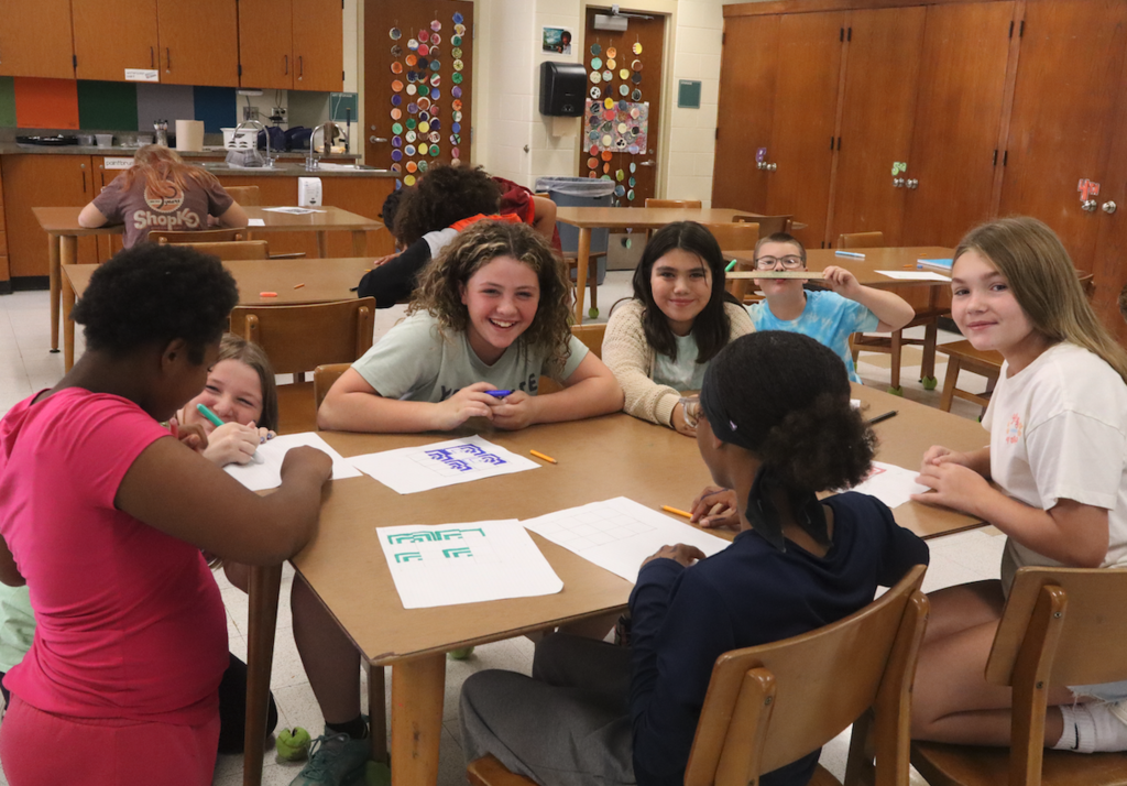 group of students in art class sitting around a table