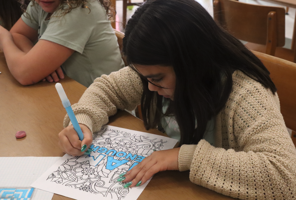 girl working on picture in art class