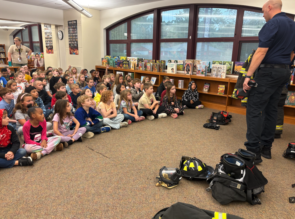 kids listening to fire fighters