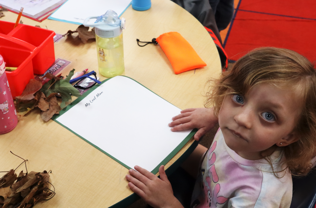little girl sitting at a table