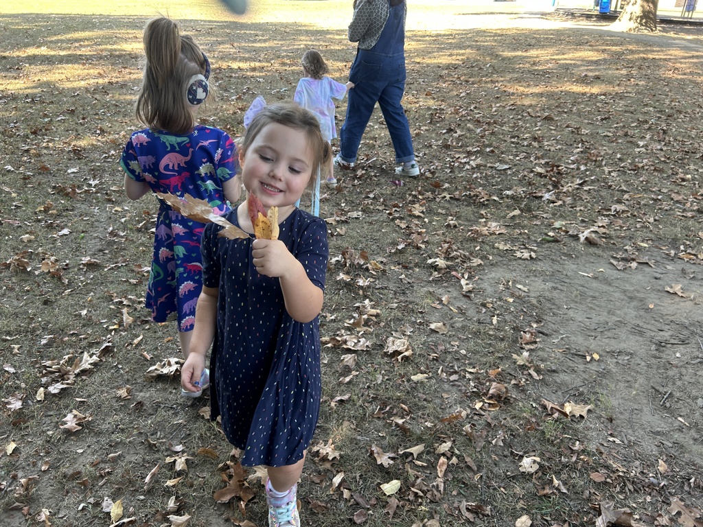 students picking up leaves