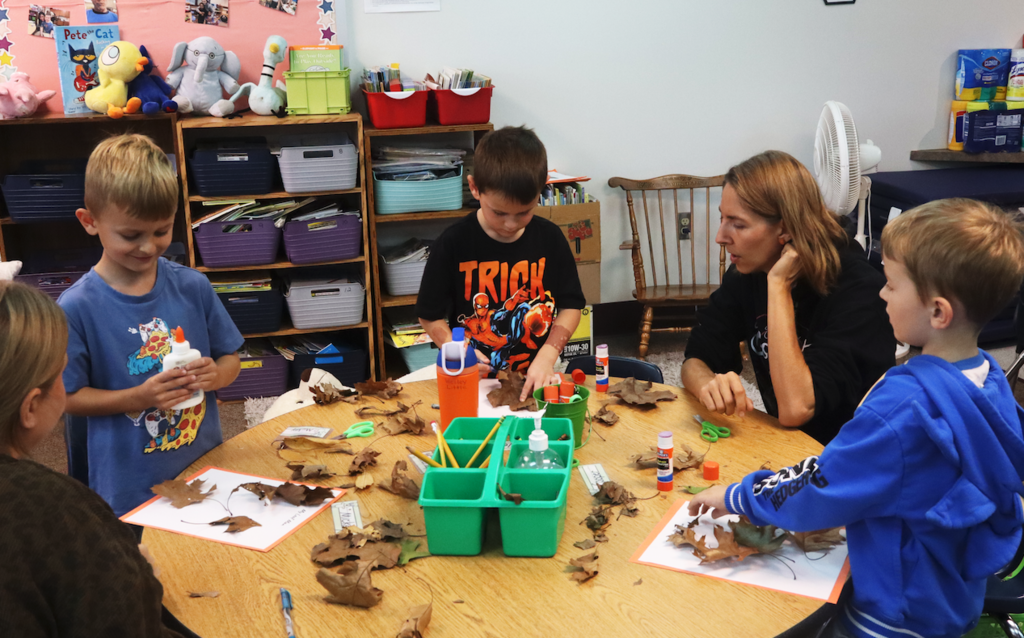 students around a table in a classroom
