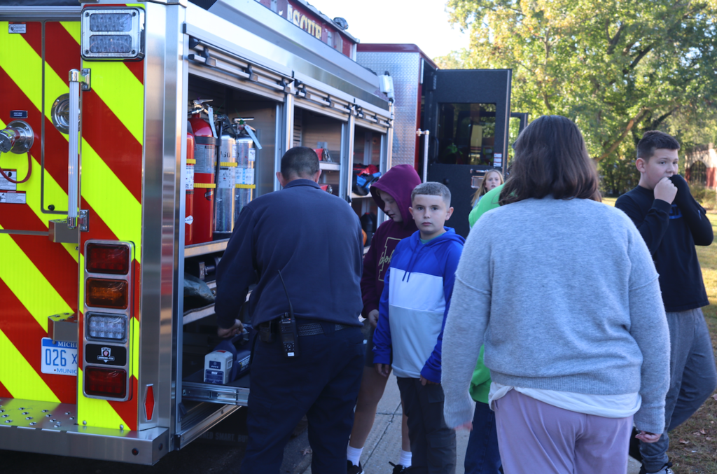 firefighters showing kids firetruck