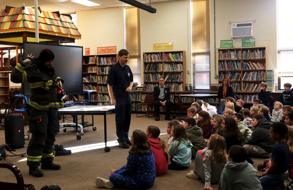 kids listening to firefighters
