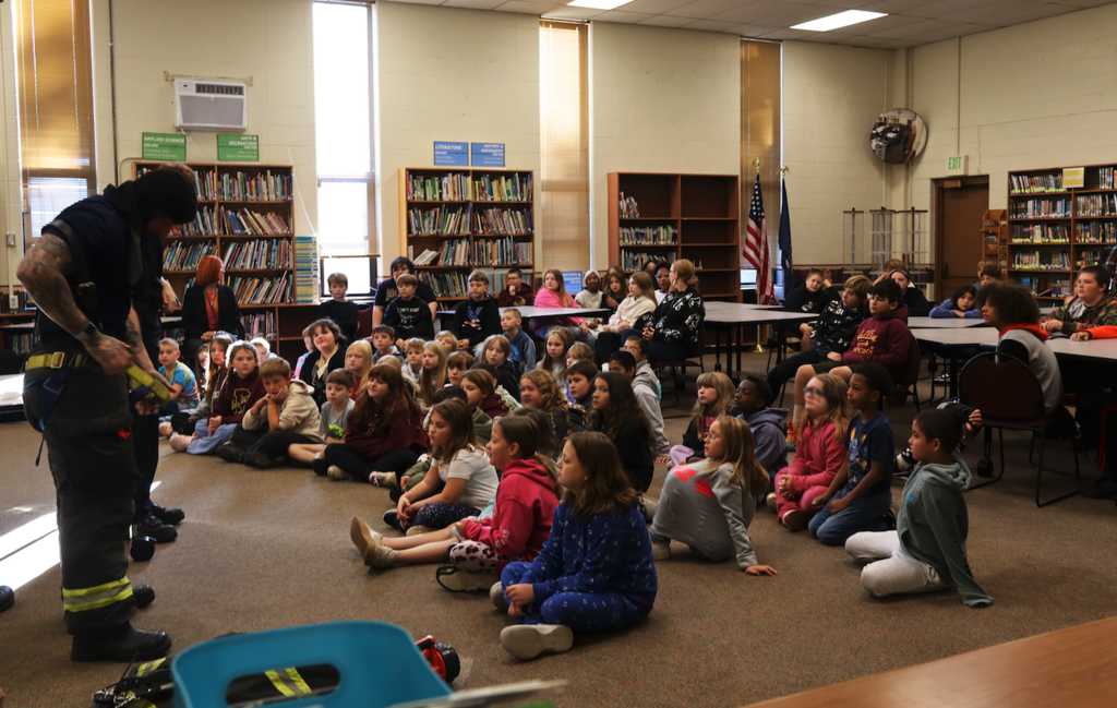 kids listening to firefighters