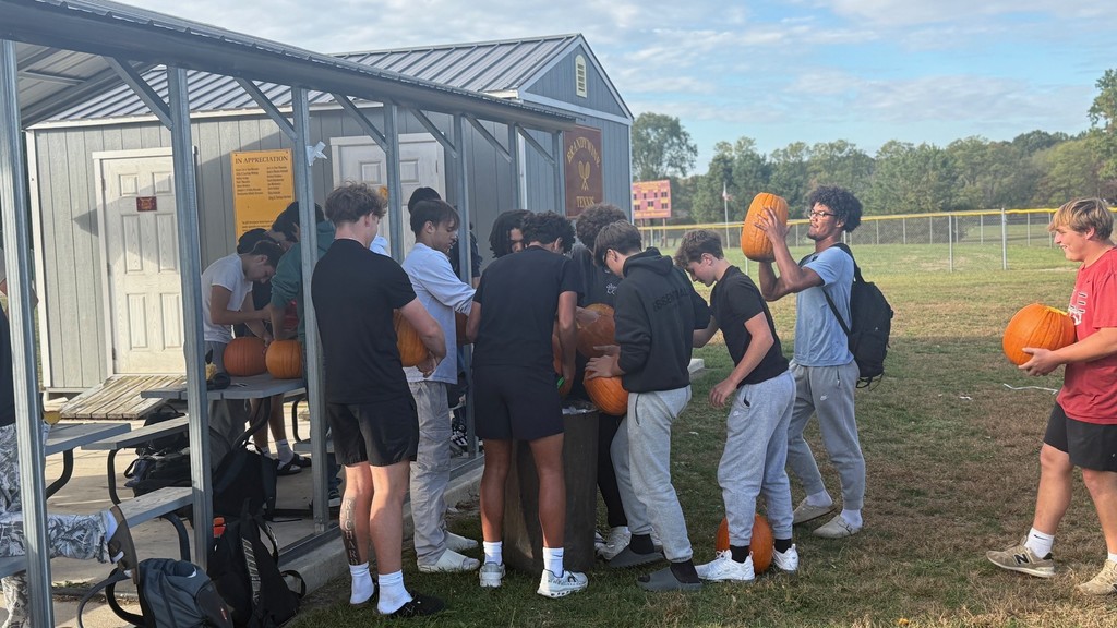 students carving pumpkins
