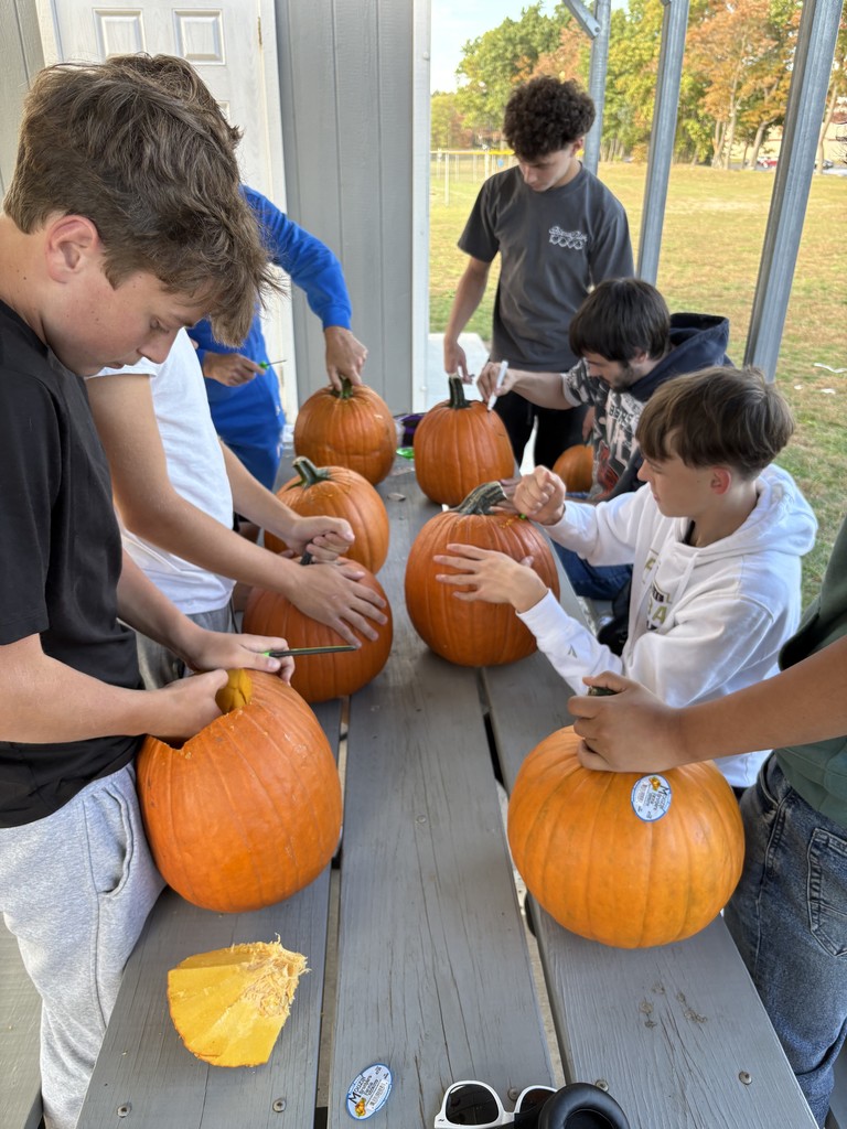 students carving pumpkins