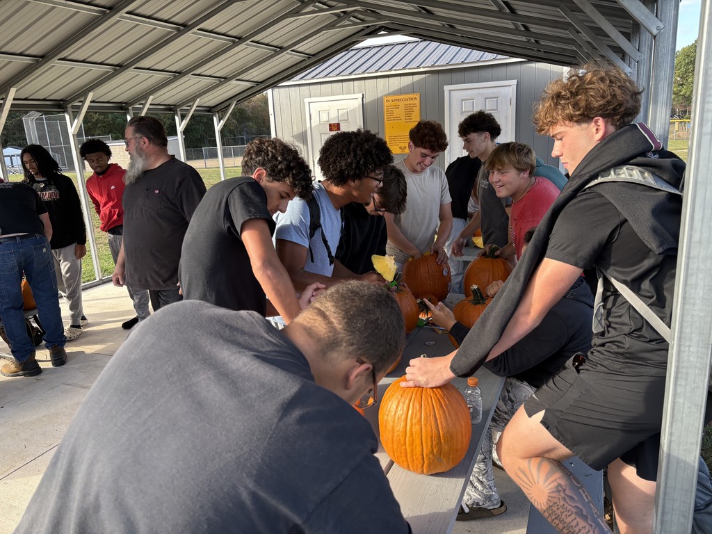 students carving pumpkins
