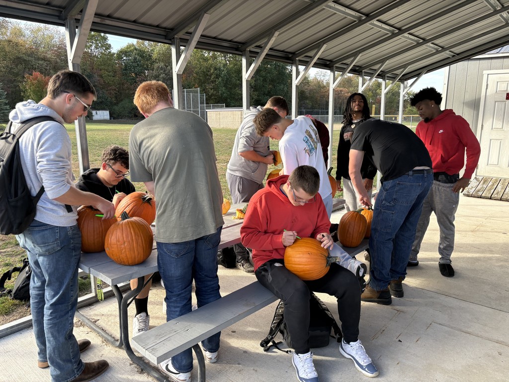 students carving pumpkins