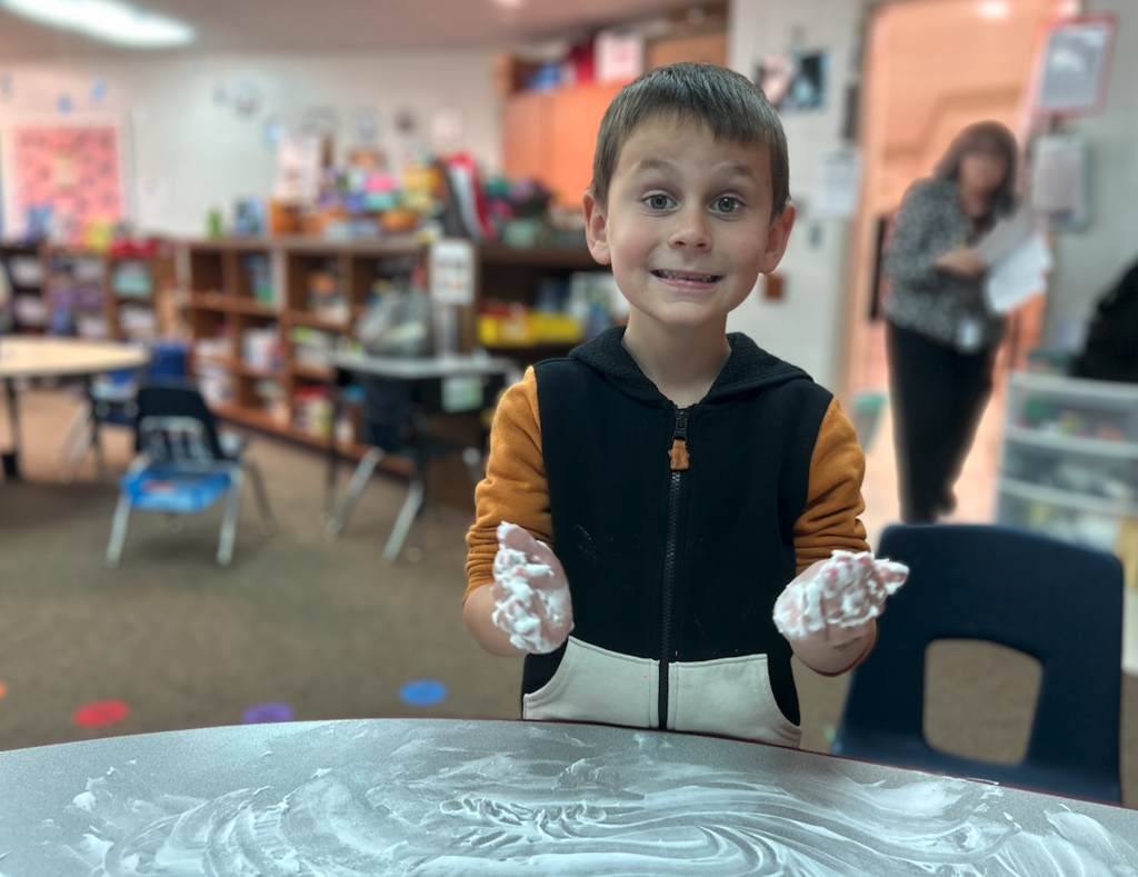 little boy with shaving cream on his hands