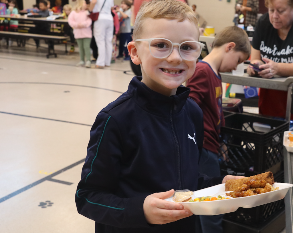 student with lunch tray